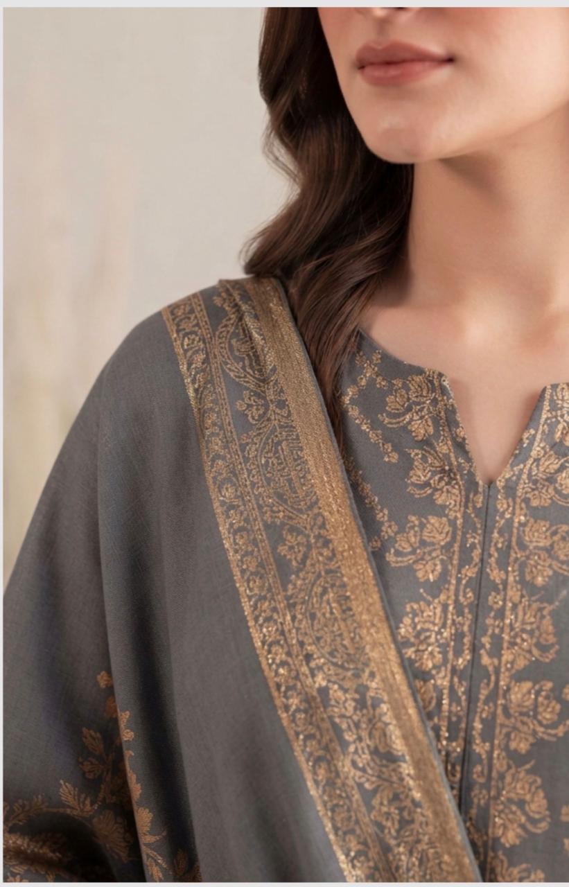 Charcoal grey and golden printed women's winter 3-piece suit by Noreya Loom, featuring a stylish top, pants, and matching dupatta.