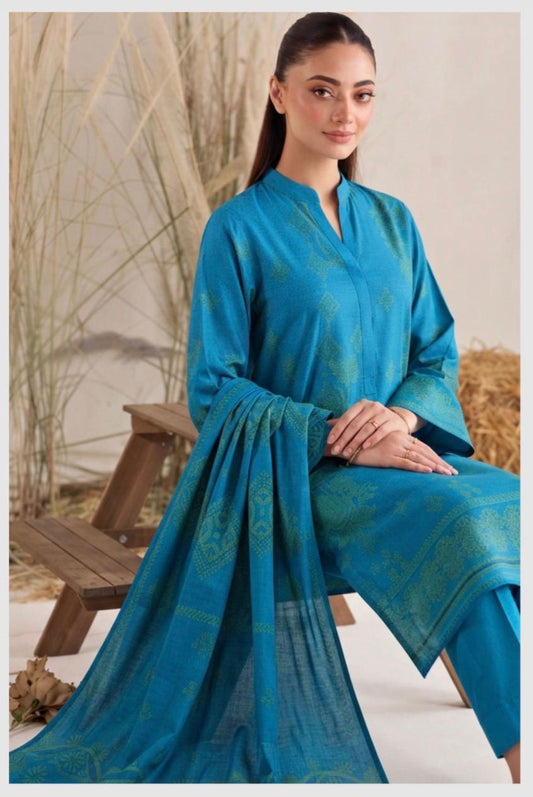 Elegant teal blue printed women’s winter 3-piece suit by Noreya Loom, featuring a stylish top, pants, and matching dupatta.