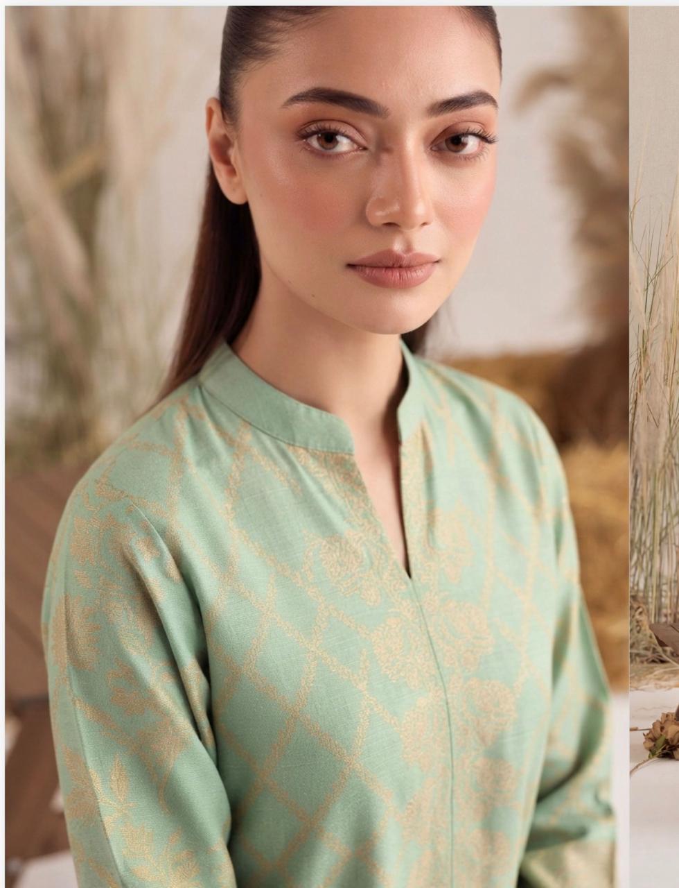 Mint green and gold printed women's winter 3-piece suit by Noreya Loom, featuring intricate patterns and elegant fabric.