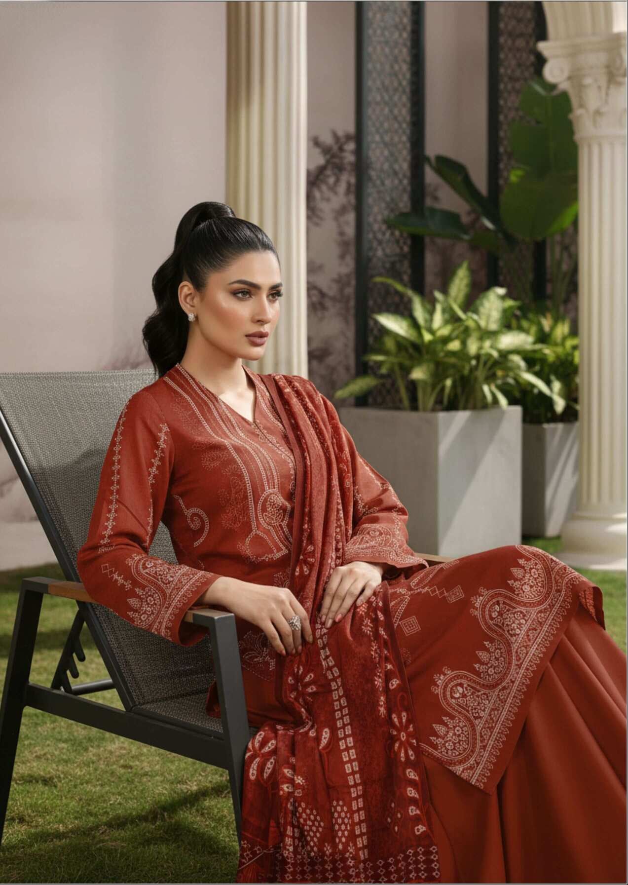 Rust brown embroidered 3-piece Pakistani suit with intricate designs, featuring a long kurta, matching trousers, and dupatta.