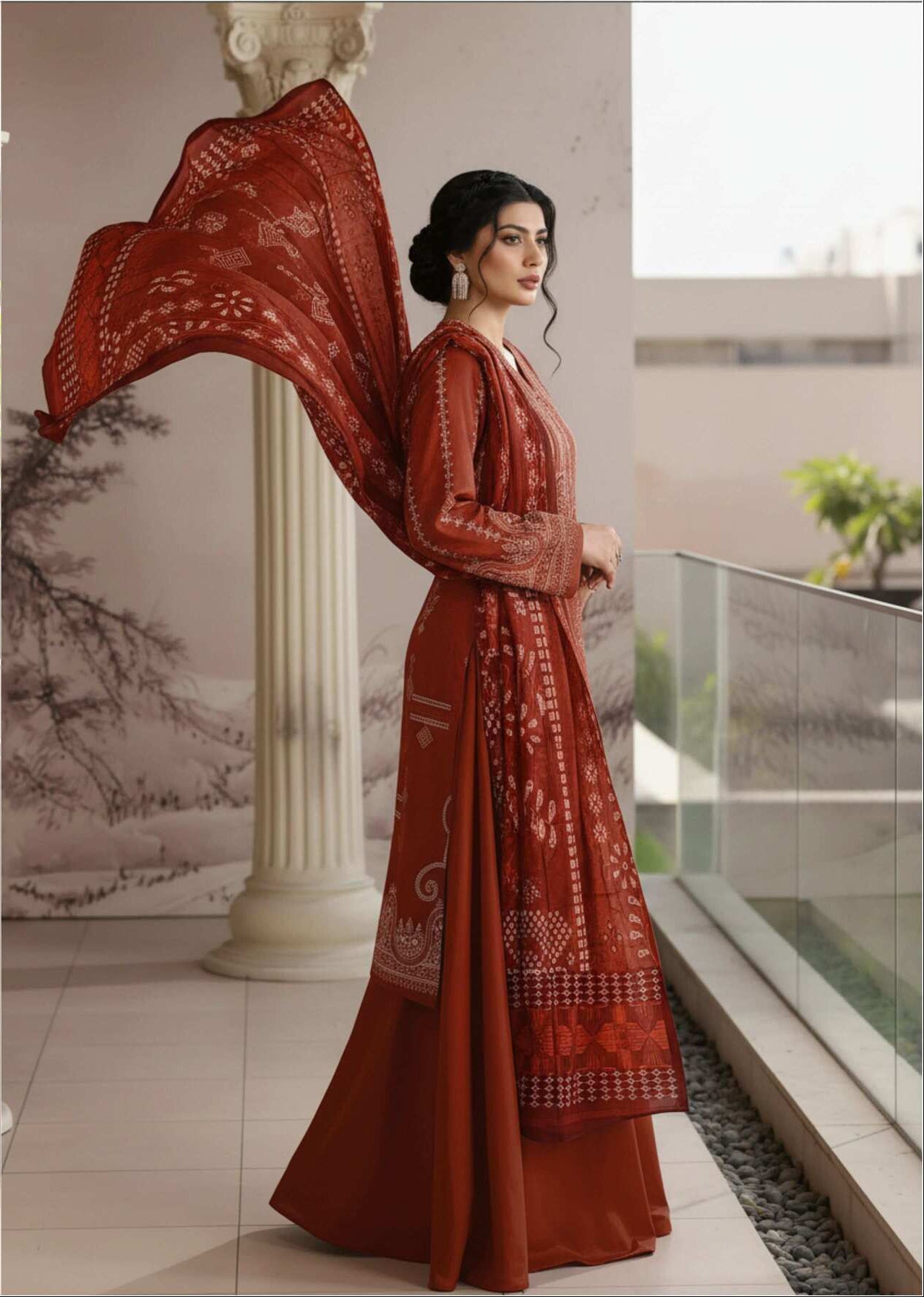 Rust brown embroidered 3-piece Pakistani suit with intricate designs, featuring a matching top, trousers, and dupatta.