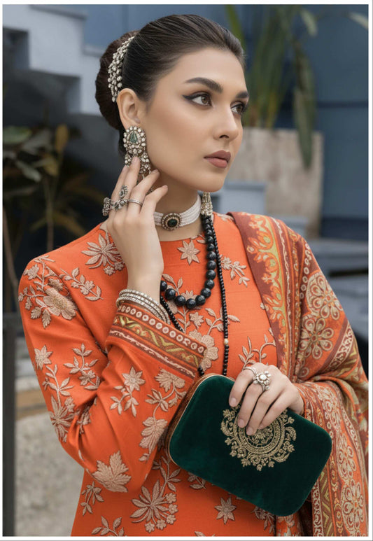 Rust orange luxury 3-piece suit with embroidered details and printed dupatta, featuring intricate craftsmanship and elegant design.