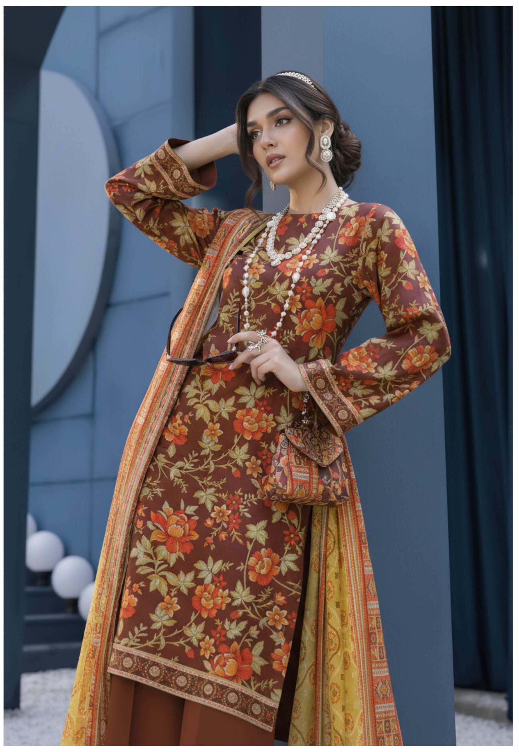 Maroon floral printed 3-piece suit with mustard dupatta, featuring traditional design and intricate patterns, displayed on a mannequin.
