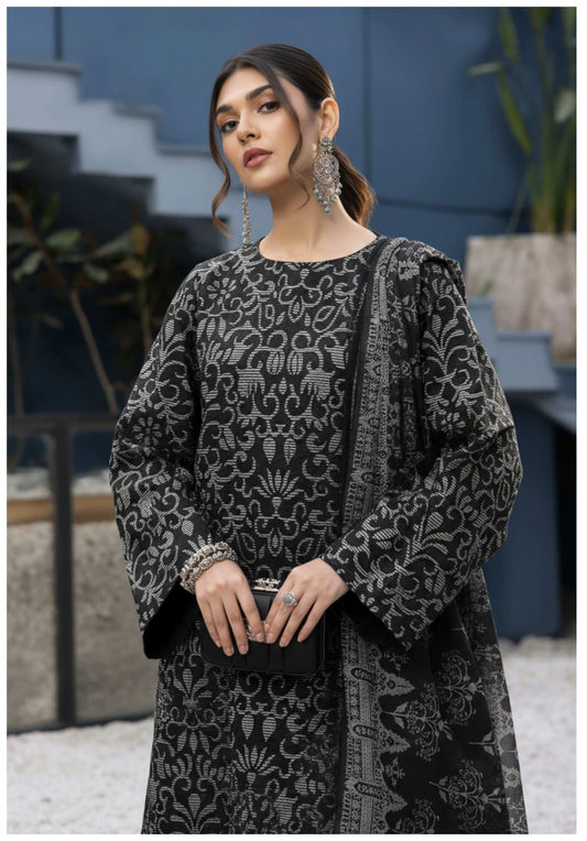 Elegant black and silver printed three-piece Pakistani suit with intricate design, showcasing traditional style and craftsmanship.