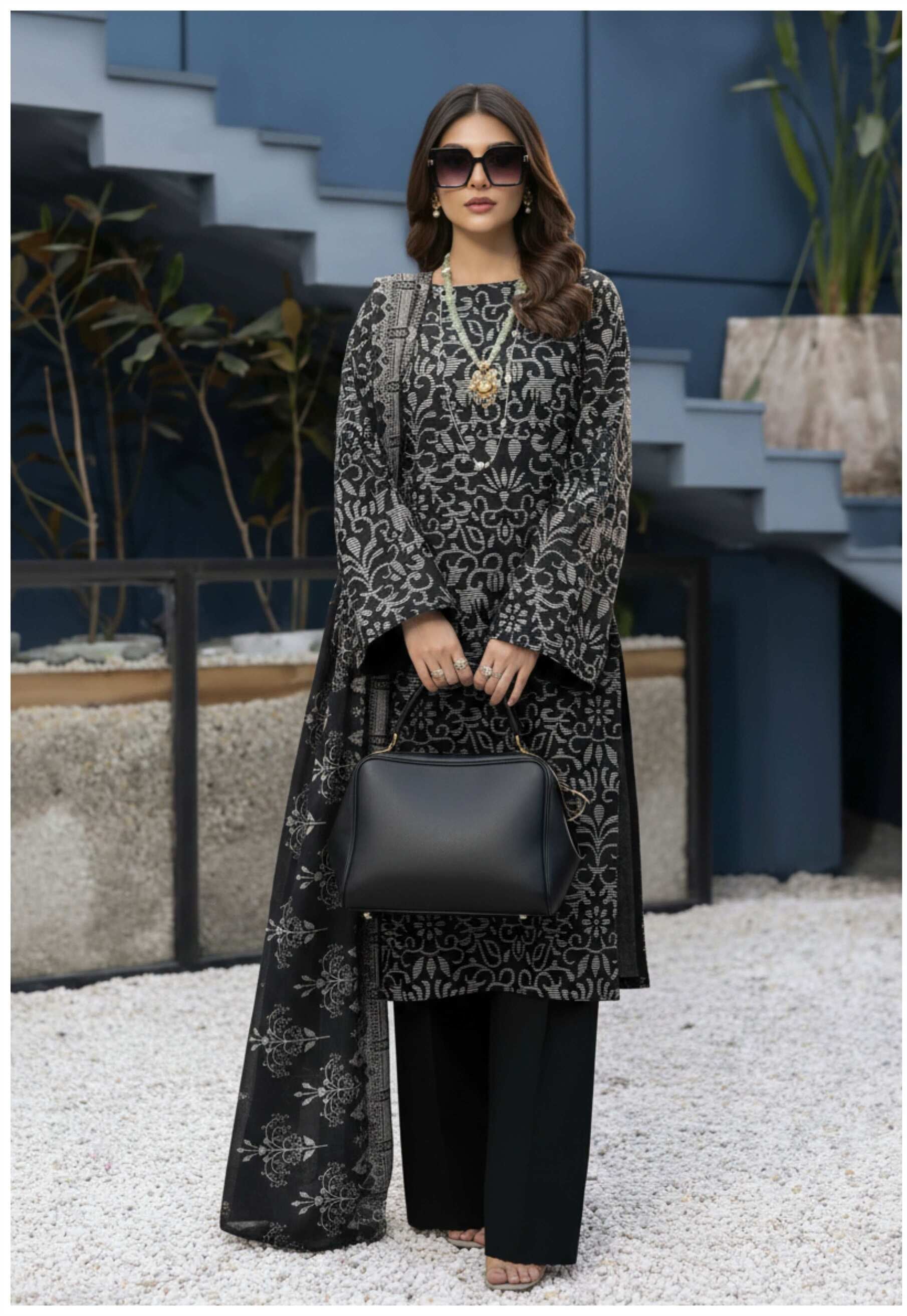 Elegant black and silver printed 3-piece Pakistani suit with intricate designs, showcasing traditional style and craftsmanship.