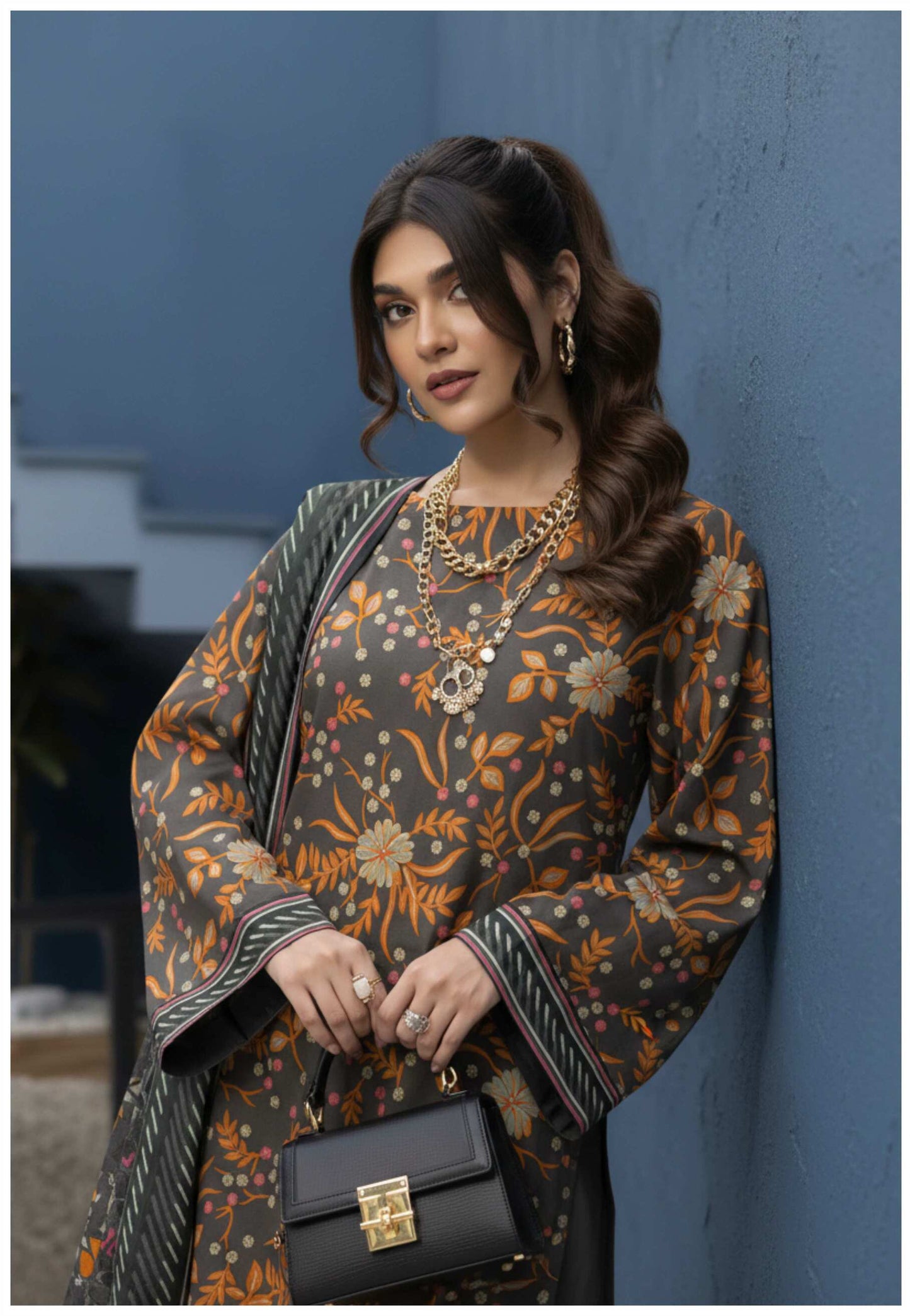 Elegant grey and orange floral printed 3-piece Pakistani suit with intricate embroidery and traditional design, displayed on a mannequin.
