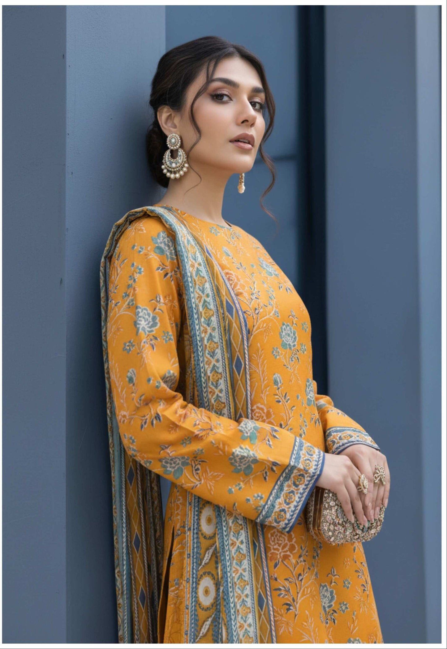 Mustard yellow floral printed 3-piece suit from Pakistani collection, featuring traditional embroidery and elegant fabric details.