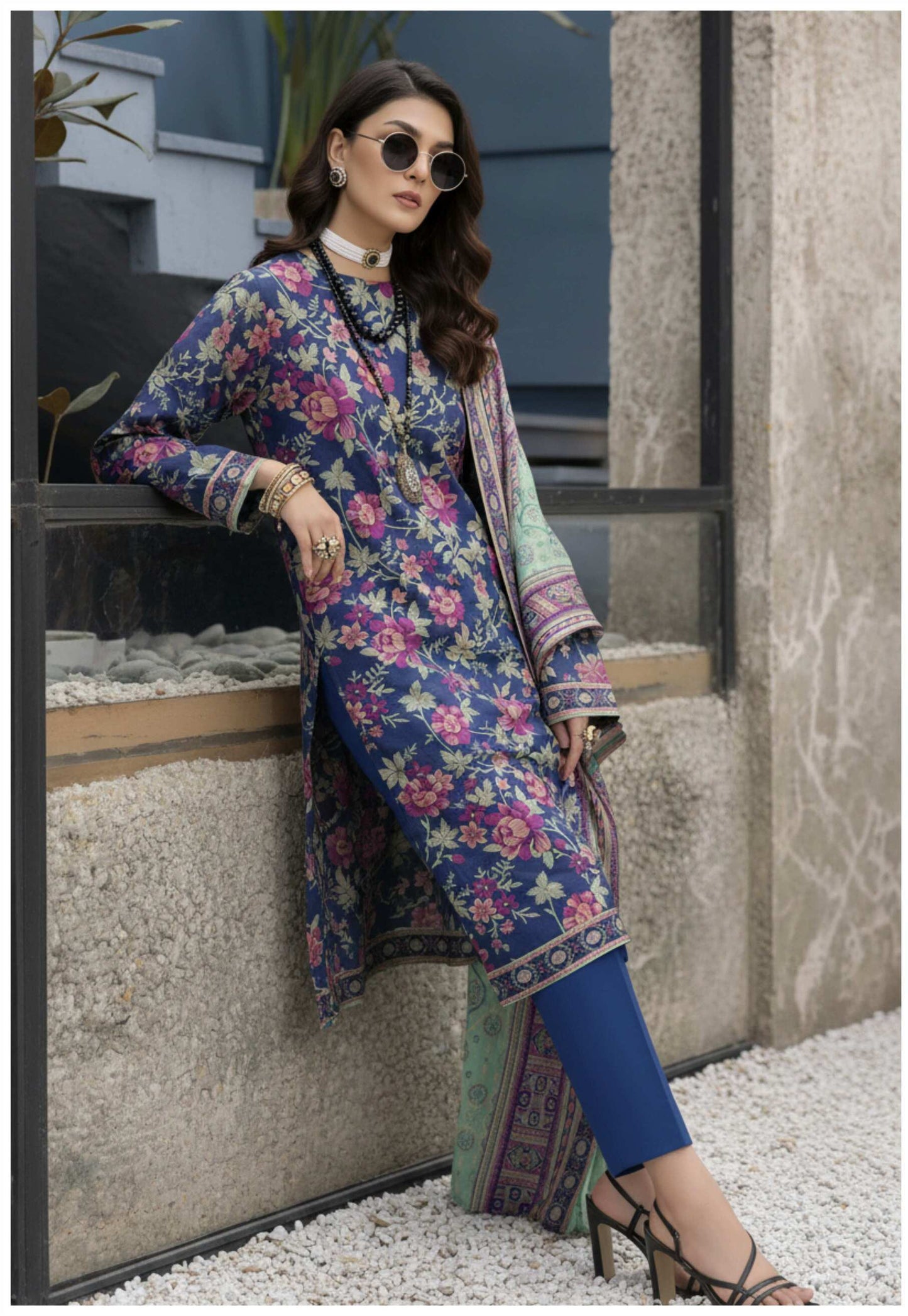 Royal blue floral printed 3-piece Pakistani suit with intricate embroidery and matching dupatta, showcased on a traditional mannequin.