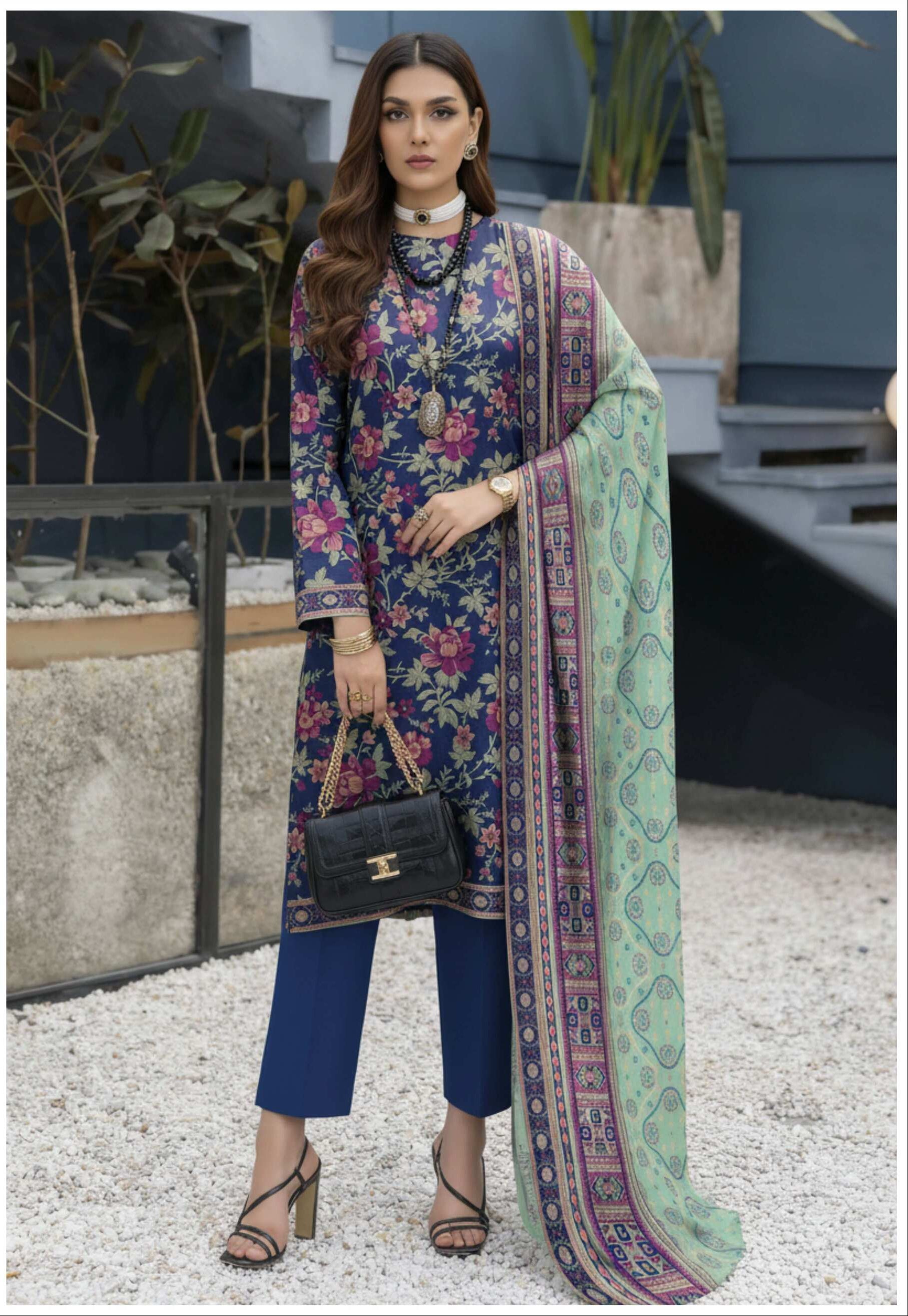 Royal blue floral printed 3-piece Pakistani suit, featuring intricate embroidery and elegant design, worn by a model.