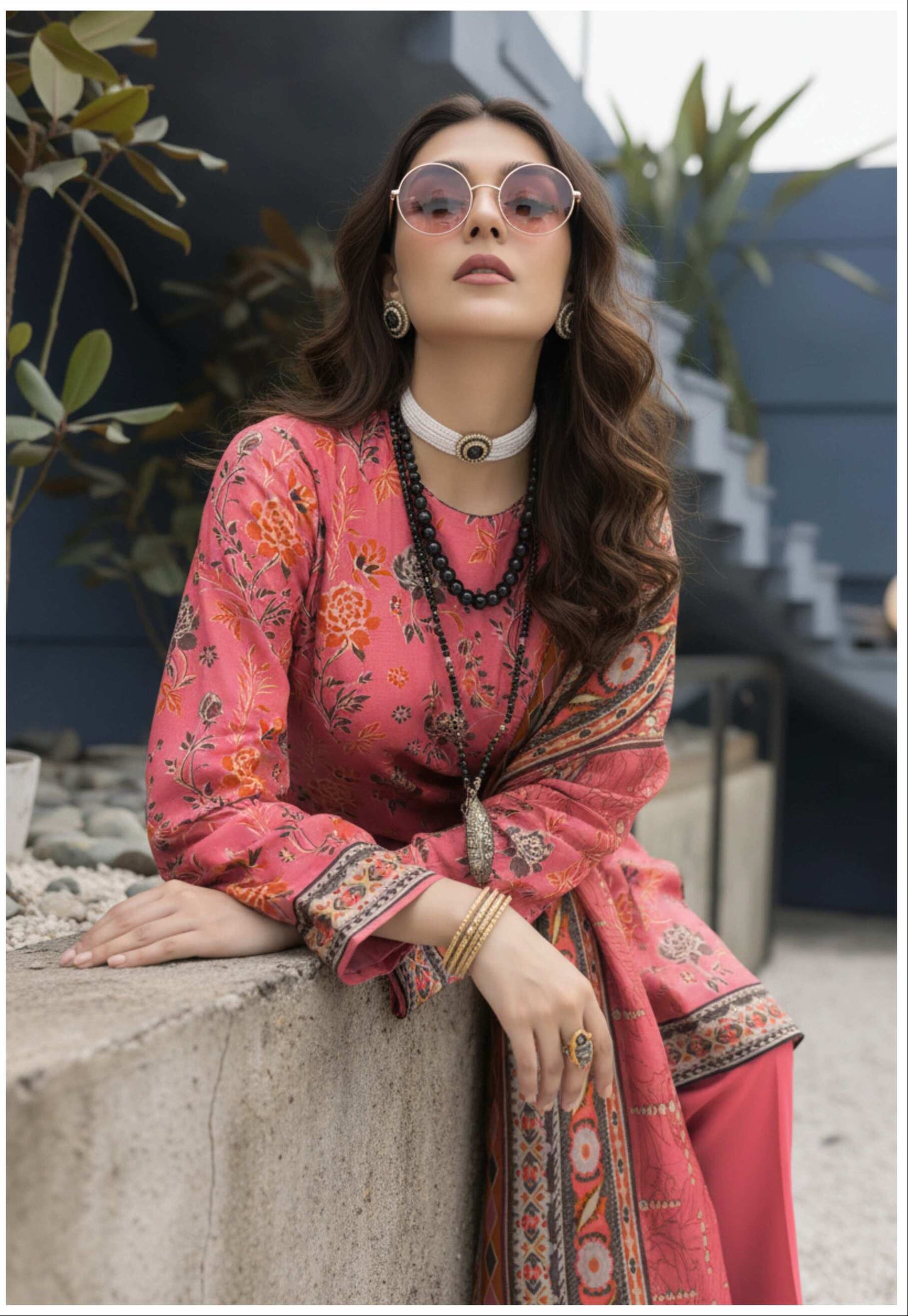 Elegant coral pink floral printed 3-piece suit from Pakistani collection, featuring intricate embroidery and matching fabric details.