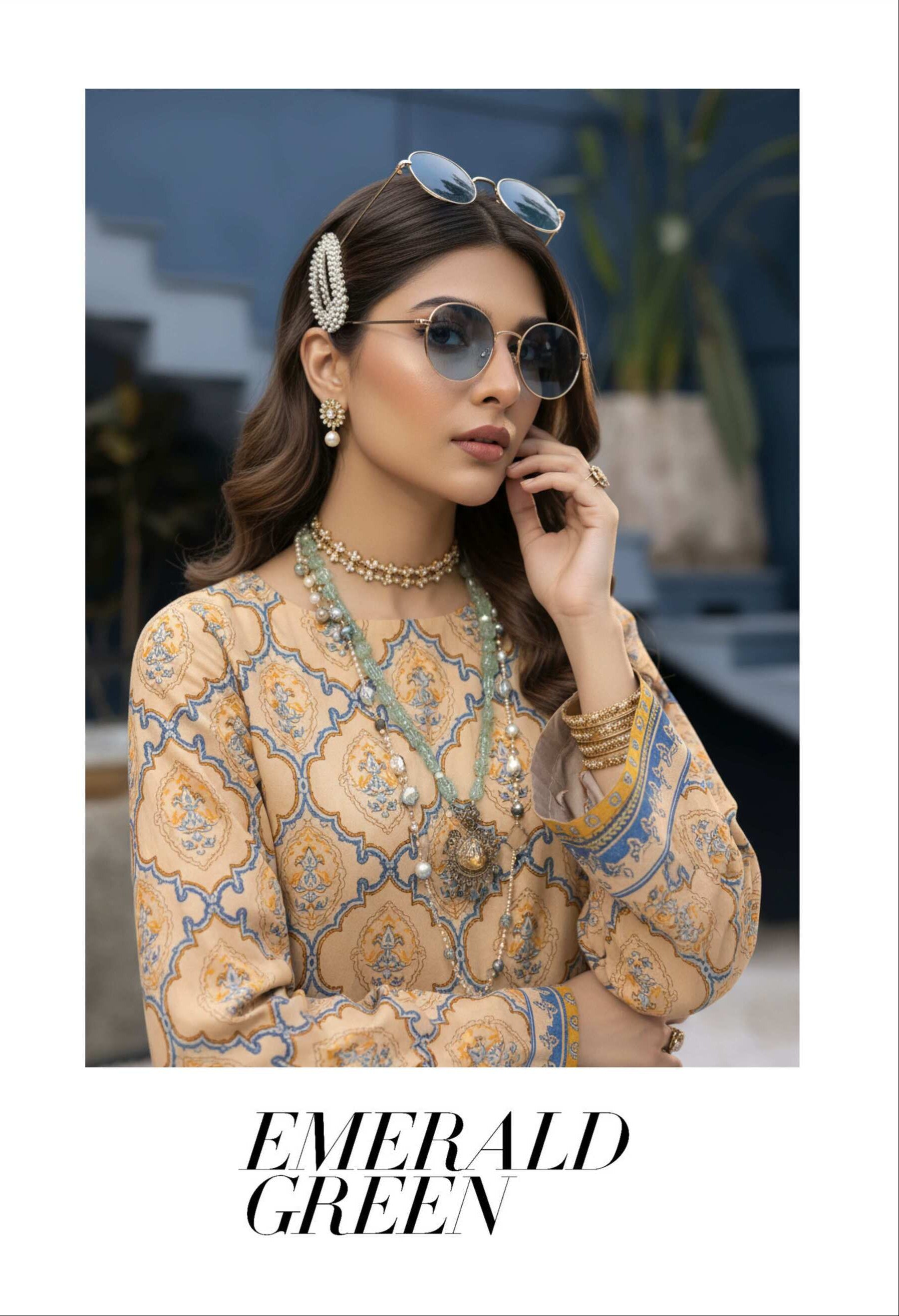 Elegant beige printed 3-piece lawn suit with matching blue printed dupatta, featuring intricate designs and lightweight fabric.