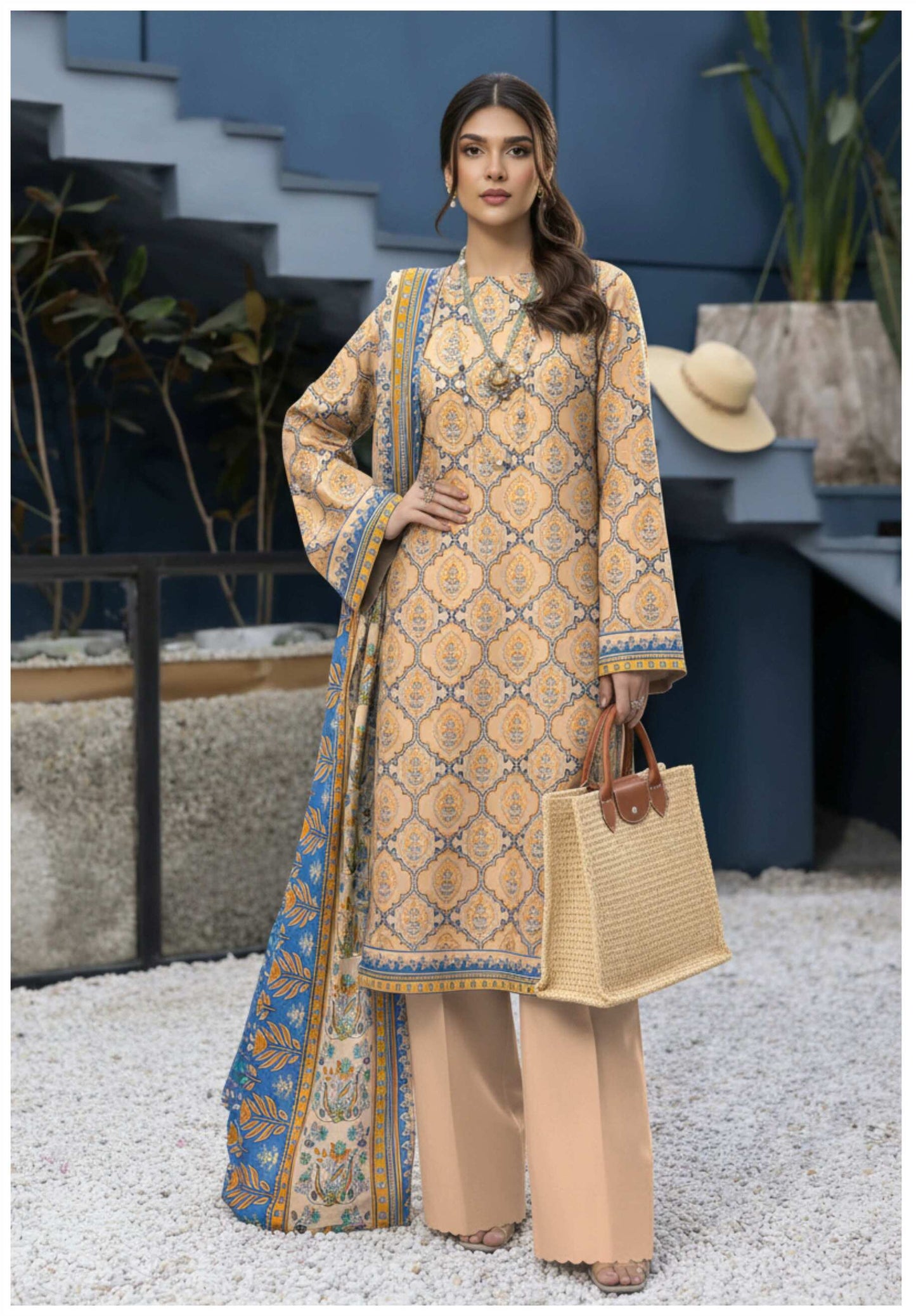 Elegant beige printed 3-piece lawn suit with blue printed dupatta, showcasing intricate patterns and lightweight fabric.