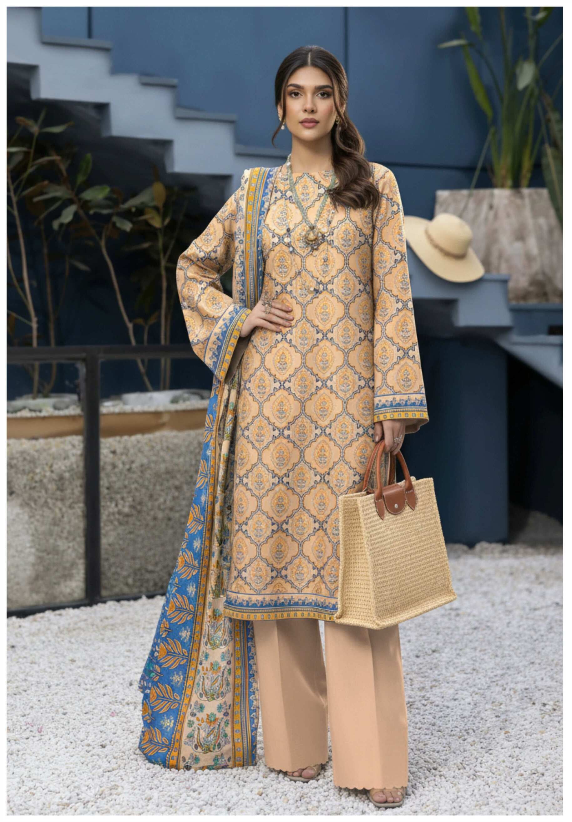 Elegant beige printed 3-piece lawn suit with blue printed dupatta, showcasing intricate patterns and lightweight fabric.
